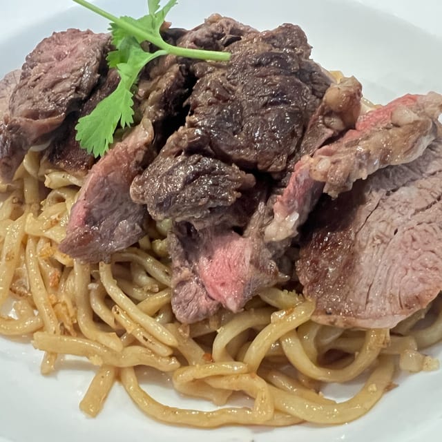 Ribeye Steak Over Garlic Chowmein Noodles.