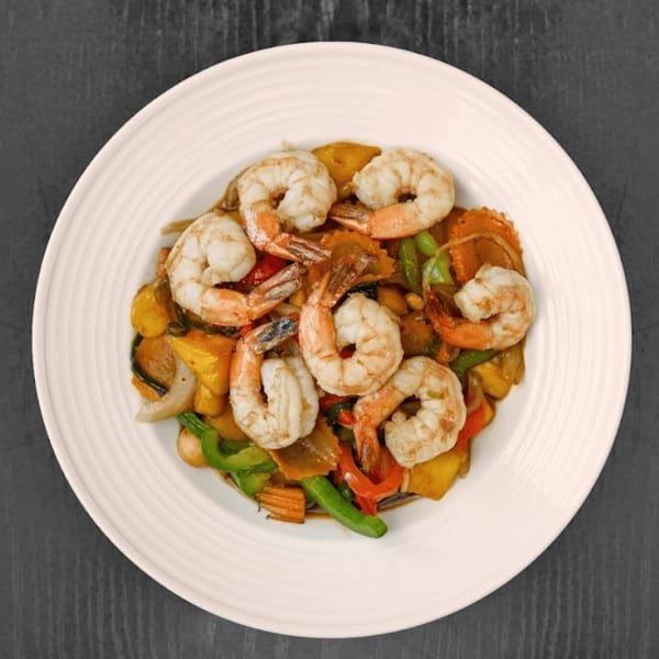 Thai Recipe Cuisine's shrimp stir-fry with colorful vegetables on a white plate.