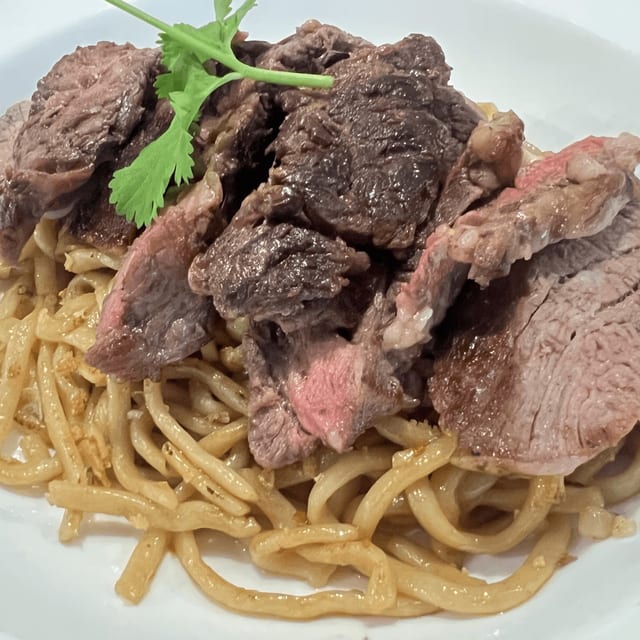 Ribeye Steak Over Garlic Chowmein Noodle.